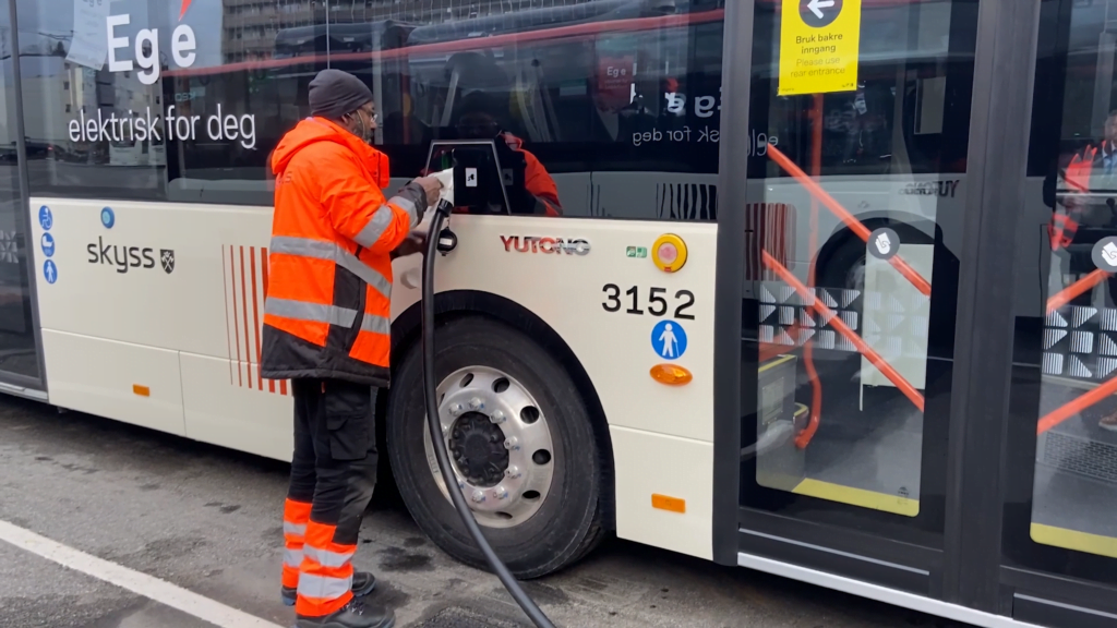 An employee starts charging the bus